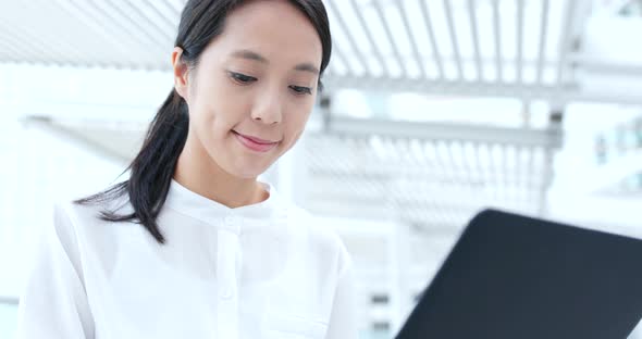 Business woman use of notebook computer in city