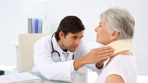 Doctor Checking Retired Patient In Neck Brace