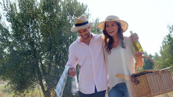 Romantic couple walking with wicker basket in olive farm 4k