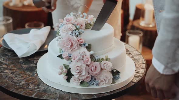 Detail of Wedding Cake Cutting By Newlyweds Wedding Cake Decorated with Flowers Pastel Pink Roses