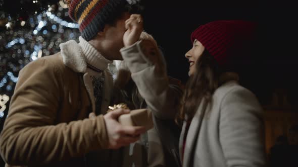 Best Friends Presenting Gifts to Each Other at Xmas Night at Old Town Square