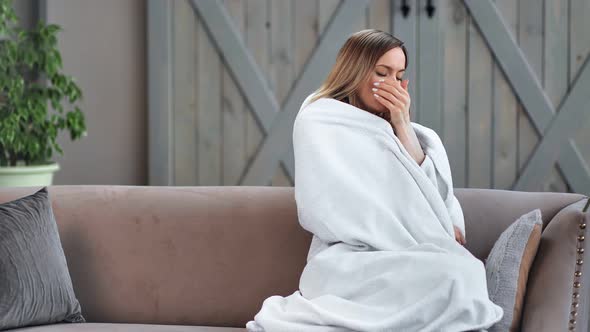 Unhealthy Female Have Influenza Sit on Sofa in Wrapped Blanket