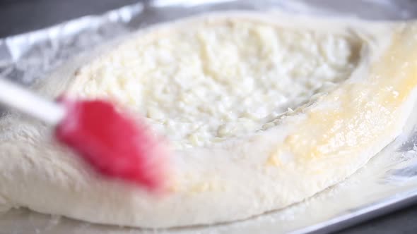 Baker prepares a pie with a cottage cheese