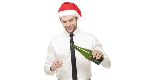 Slow Motion Young Handsome Businessman Pouring and Drinking Champagne Over White Background.