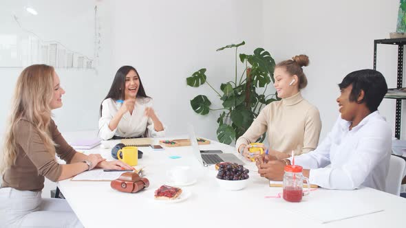 Young Ladies Wearing Casual Clothes Work Together in Light Office