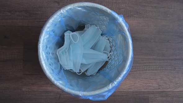 Dispose the Medical Face Mask and Gloves in a Bin, Top View