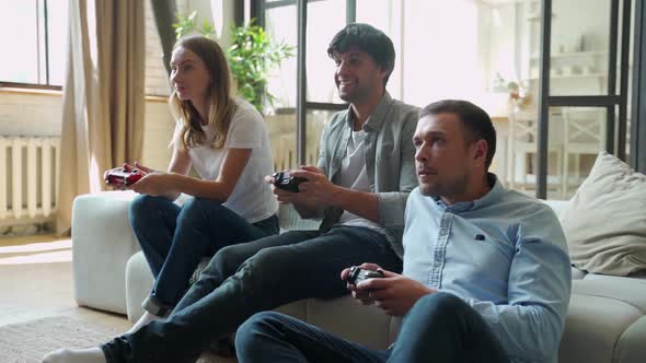 Friends Playing Video Game Together. Celebrate Victory.