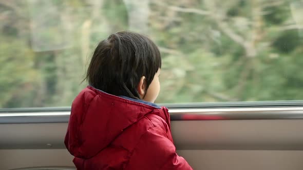 Happy Asian Child Looking Out Train Window Outside