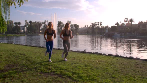 Athletic Twins Running In The Park Slow-Motion