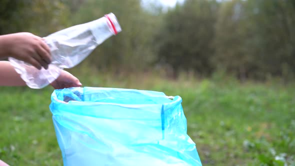 Children Remove Plastic Garbage and Put It in a Biodegradable Garbage Bag in the Open Air