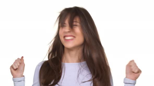 Happy Caucasian Young Brunette Lady in Lavanderblue Sweater Actively Rejoicing Over White Background