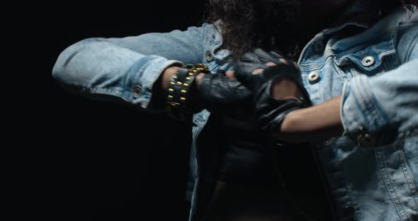 Close Up of a Young Woman in Denim Clothes Punching Her Hand, Tough Criminal, 