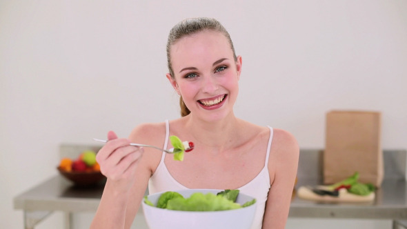 Smiling Model Eating A Big Bowl Of Salad