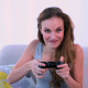 Happy Model Playing Video Games On The Couch - VideoHive Item for Sale