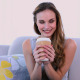 Happy Model Drinking A Coffee On The Couch - VideoHive Item for Sale