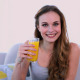 Happy Model Drinking Orange Juice On The Couch - VideoHive Item for Sale