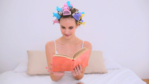 Young Model In Hair Rollers Reading A Book