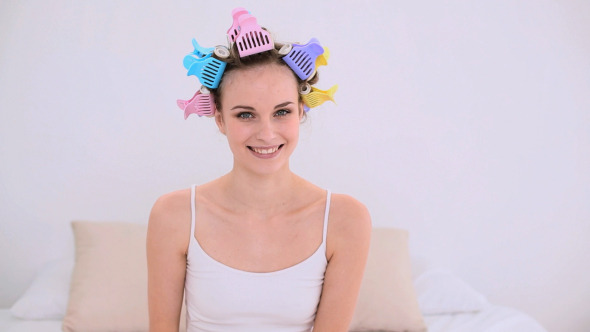 Young Model In Hair Rollers Holding Red And Green