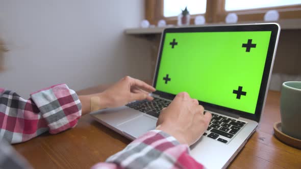 Woman Using Laptop with Green Screen