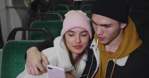 Close Up of Young Couple Looking at Smartphone Screen While Watching Video. Happy Girlfriend and