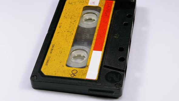 Audio Cassette Rotates on White Background