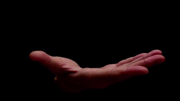 Male hands showing gesture isolated on black background