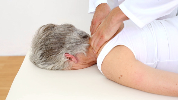 Doctor Massaging Senior Patients Shoulders