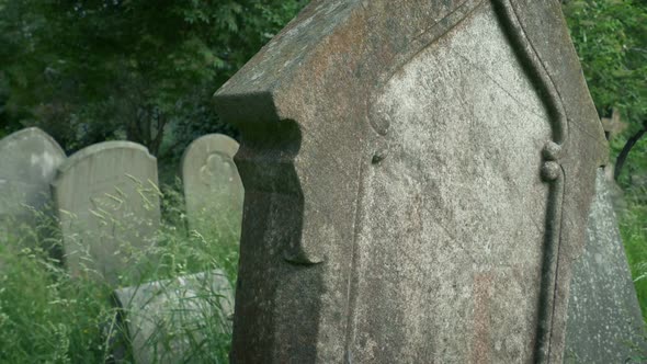 Passing Plain Tombstones In Churchyard