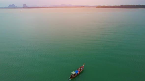 An aerial view of a boat cruising forward into the estuary