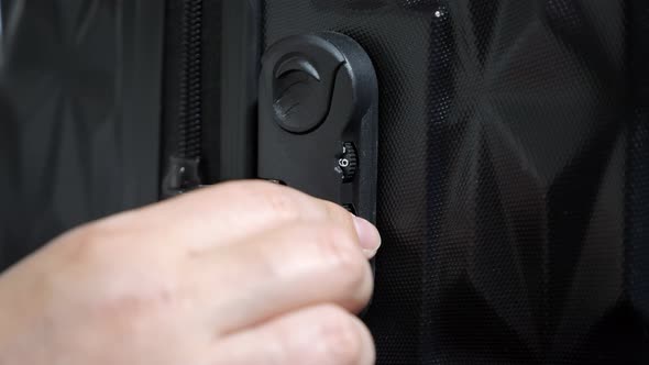 Woman's Hands Open Suitcase Combination Lock on the Suitcase