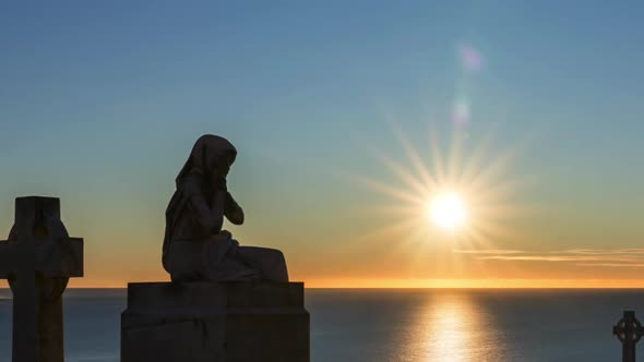 Statue of a Women Praying at Sunrise