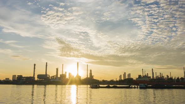 4k timelapse of 4k Oil refinery  petrochemical plant timelapse at sunrise with reflection of river