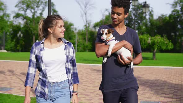 Attractive Multiethnic Couple Walking Together in Park Enjoying the Day