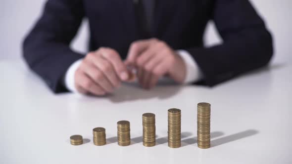 Banker Putting Coin on Pile, Deposit Interest Growing, Successful Investment