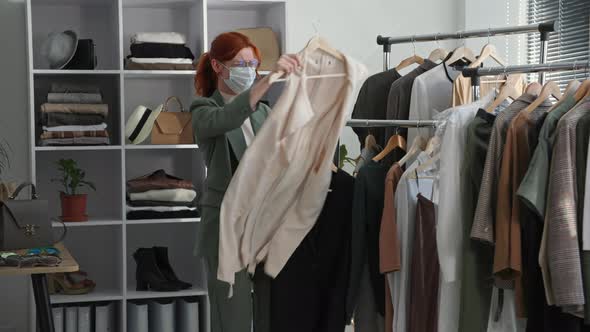 Shopping Young Happy Woman Wearing a Medical Mask Rejoices the Opening of Stores and Picks Up Items