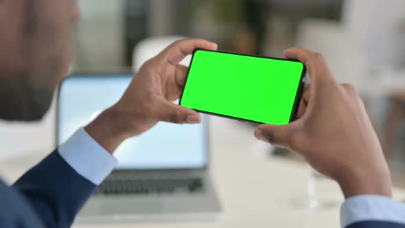 Businessman Watching Smartphone with Green Chroma Key Screen