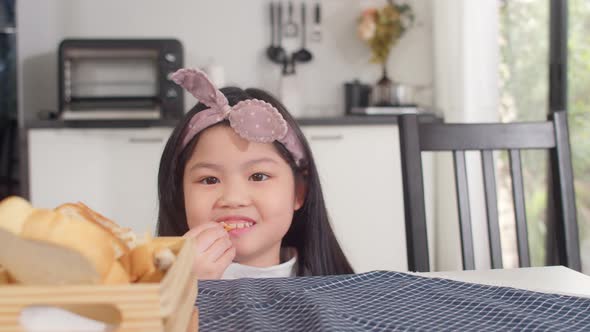 Asian women feeling happy pick sandwich which put it on the table