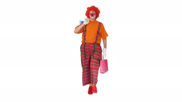 Funny Clown Walking with Shopping Bags on White Background.