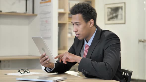 African Businessman Celebrating Success While Using Tablet