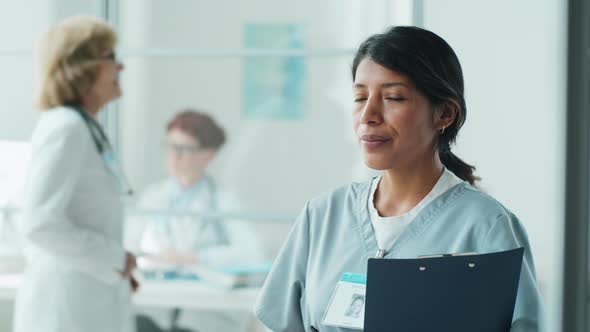 Portrait of Smiling Hispanic Nurse in Clinic