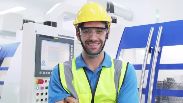 Portrait Caucasian worker man wear protective safety helmet and vest in production line of factory.