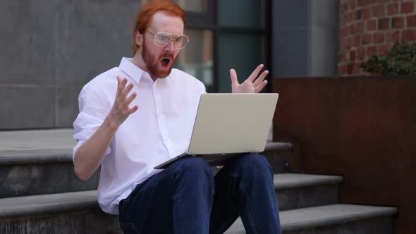 Loss Man Frustrated By Results on Laptop While Sitting on Office Stairs