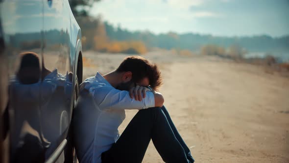 Man Sitting On Broken Car. Tensed Businessman After Bankruptcy. Unhappy Stressed Jobless Worker.