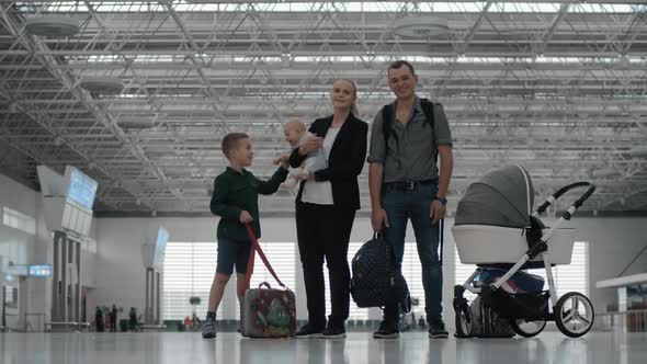 Happy Family with Two Kids at the Airport
