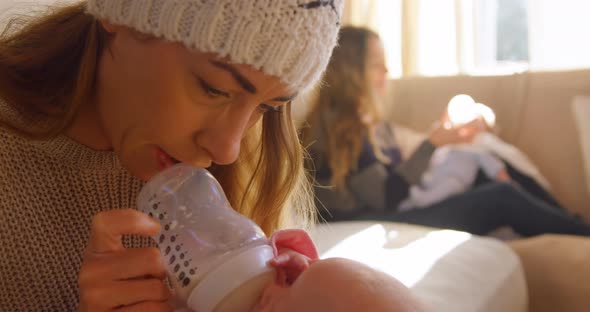 Lesbian couple feeding milk to their babies 4k