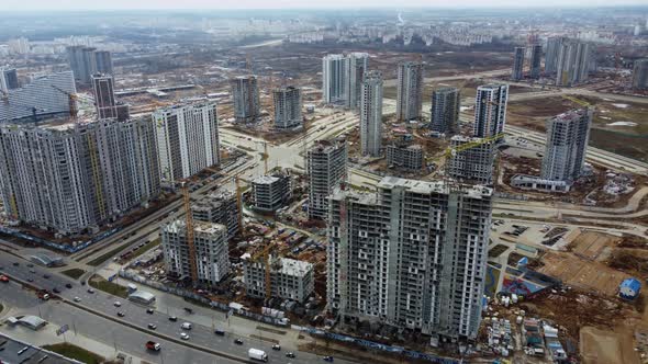 Flying over the construction site of a huge residential block of Chinese high-rise buildings. 