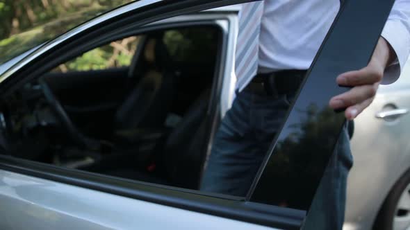 Handsome Entrepreneur Getting Into Parked Car