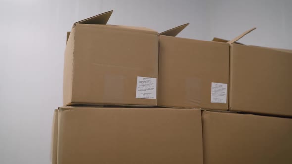 Large Cardboard Boxes in Stock Before Shipping. A Set of Cardboard Boxes in an Industrial