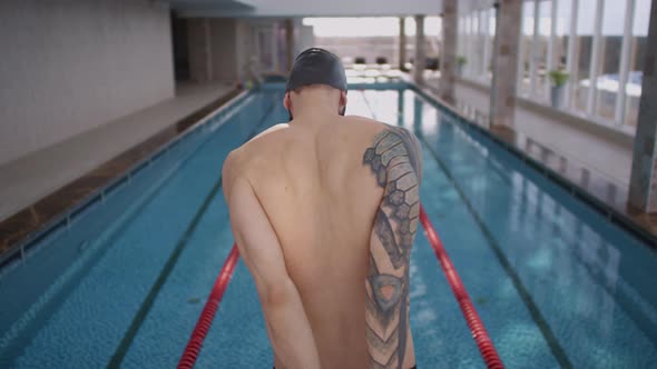 Male Swimmer Warming Up before Practice