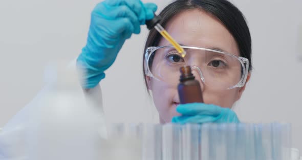 Scientist making observation of the test tube